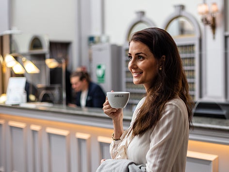 Person som dricker Zoegas-kaffe i en hotellobby