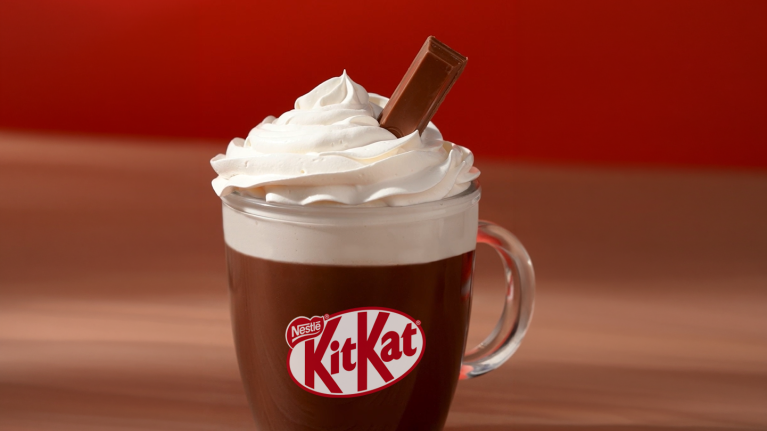 kitkat chokladdryck i glasmugg med grädde på toppen