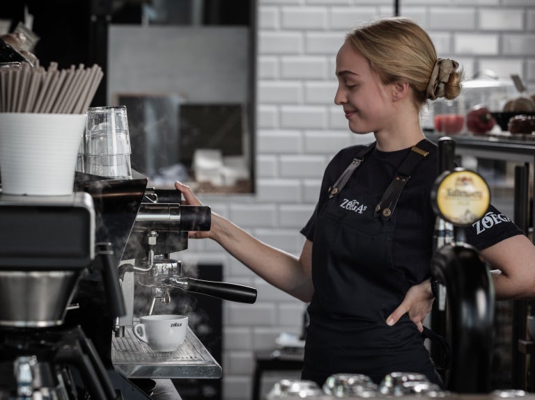 Barista i Zoégas t shirt tillreder espresso