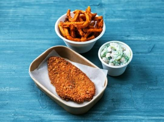 Panerad mat i en burk med en skål med pommes frites och en skål med sås bredvid